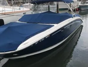 Slide: The Image of 2016 Sea Ray 290 Sundeck boat docked with blue covers and canopy. - 3