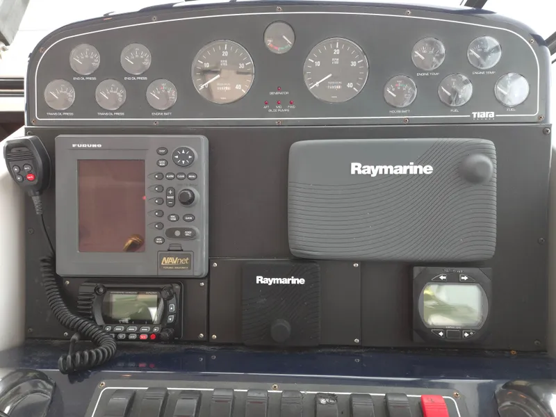Slide: The Image of Control panel of a 2002 Tiara Yachts 3500 Open with Raymarine navigation equipment. - 16