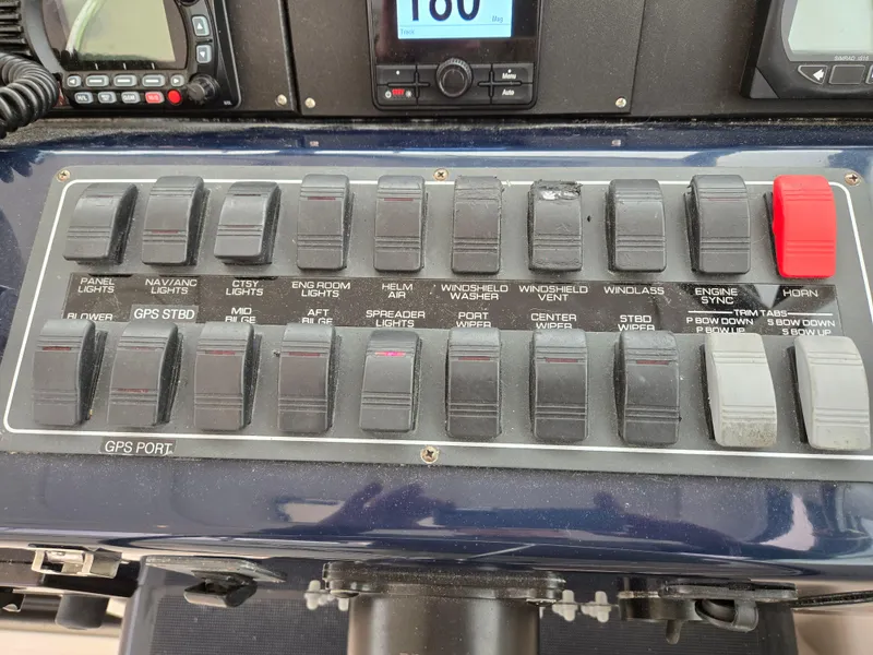 Slide: The Image of Control panel of a 2002 Tiara Yachts 3500 Open with labeled switches and instruments. - 19