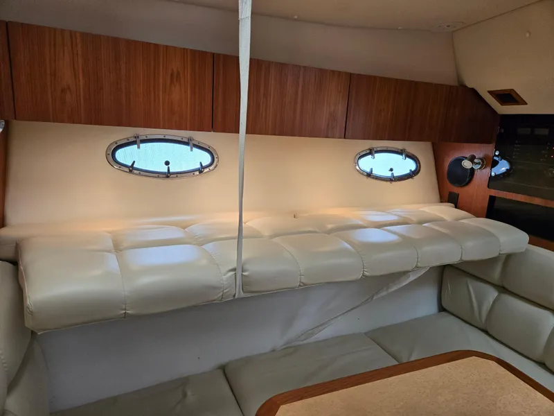 Slide: The Image of Interior of 2002 Tiara Yachts 3500 Open with leather seating and porthole windows. - 25