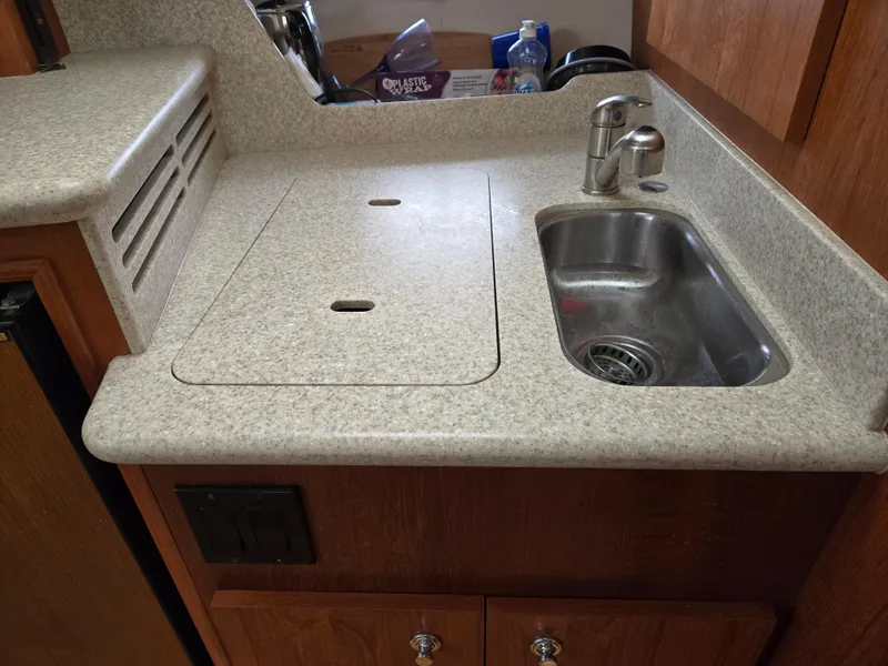 Slide: The Image of 2002 Tiara Yachts 3500 Open Hardtop kitchen sink and countertop area. - 30
