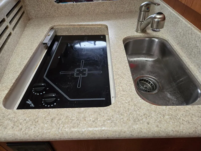 Slide: The Image of 2002 Tiara Yachts 3500 Open Hardtop kitchen with stove and sink. - 31