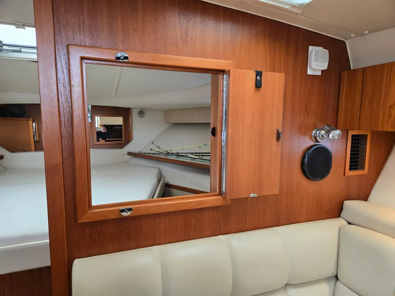 Slide: The Image of Interior of 2002 Tiara Yachts 3500 Open Hardtop with wood paneling and beige seating. - 33