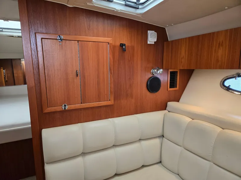Slide: The Image of 2002 Tiara Yachts 3500 Open Hardtop interior with wood paneling and cream leather seating. - 34