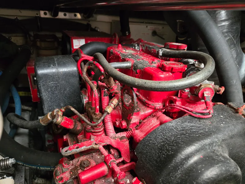 Slide: The Image of Engine compartment of a 2002 Tiara Yachts 3500 Open, featuring red mechanical components. - 39