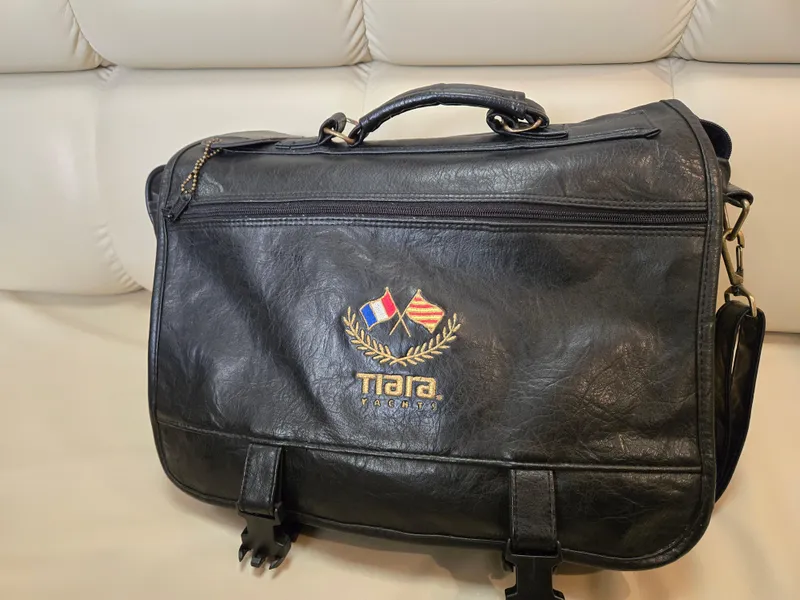 Slide: The Image of Black Tiara Yachts 3500 Open 2002 leather bag with embroidered logo on a beige sofa. - 47