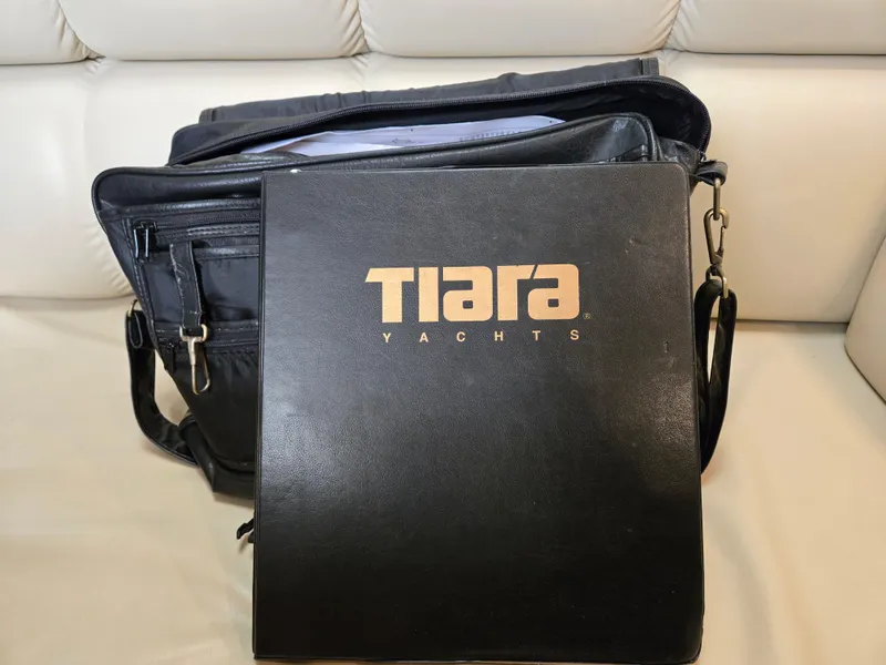 Slide: The Image of Black Tiara Yachts folder and bag on a white leather seat, 2002 model documentation. - 48