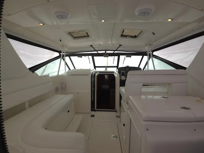 Slide: The Image of Interior of 2002 Tiara Yachts 3500 Open Hardtop, featuring white seating and helm area. - 8