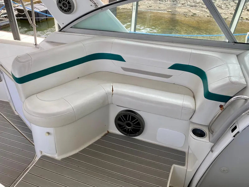 Slide: The Image of 1998 Formula 41 PC boat interior with white seating and teal accents. - 10