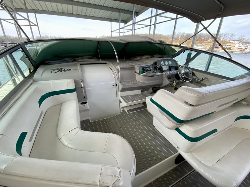 Slide: The Image of 1998 Formula 41 PC boat interior with white seating and steering console. - 11