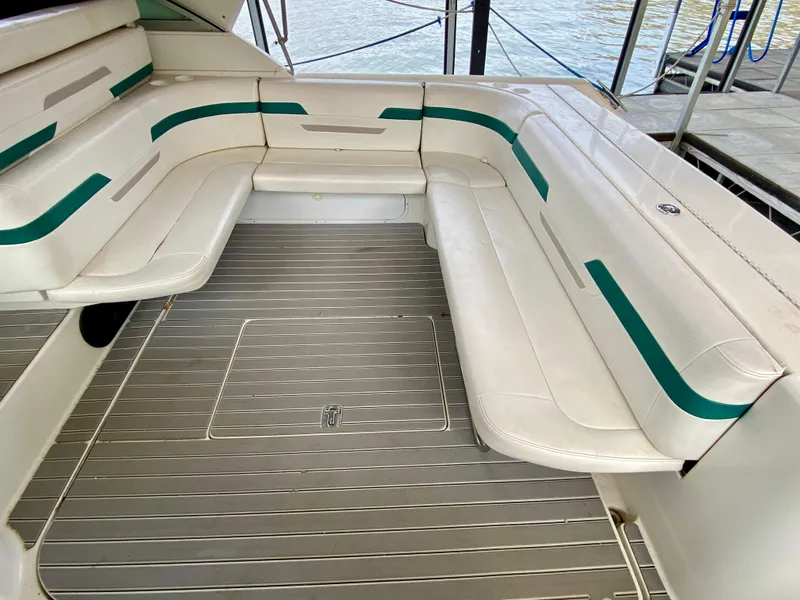 Slide: The Image of Spacious seating area on a 1998 Formula 41 PC boat with white and green upholstery. - 14