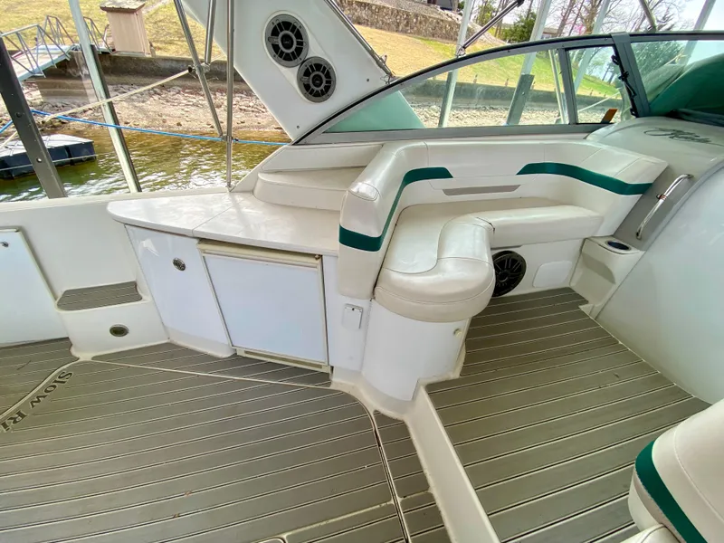 Slide: The Image of 1998 Formula 41 PC boat interior with seating and storage, docked by the water. - 15