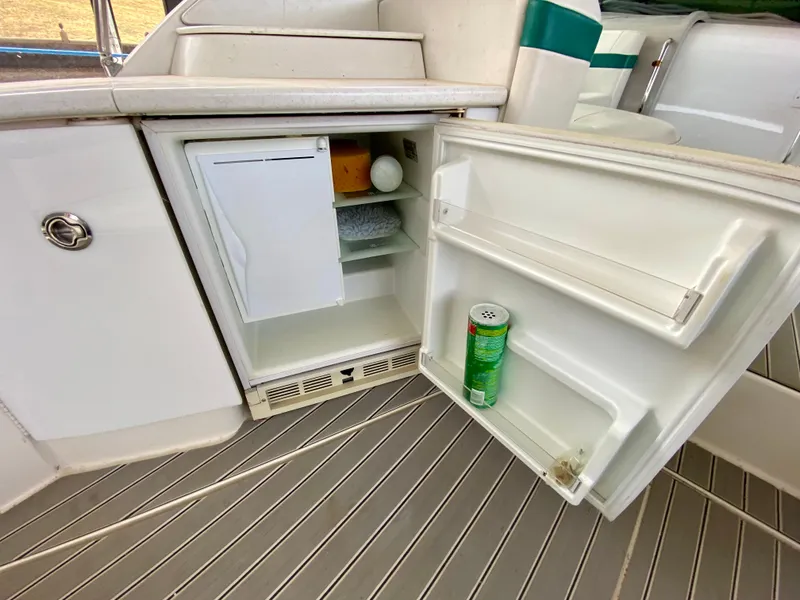 Slide: The Image of 1998 Formula 41 PC boat interior with open mini fridge, showing drinks and snacks. - 17