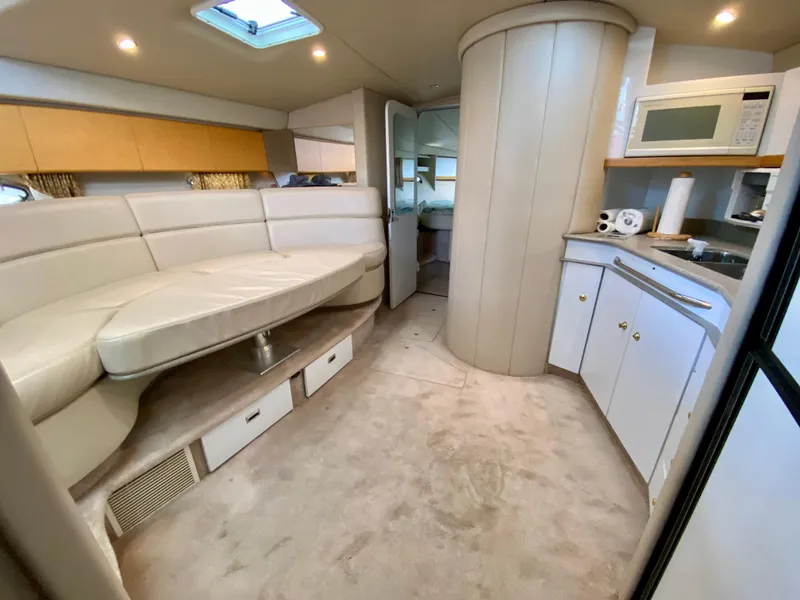 Slide: The Image of 1998 Formula 41 PC yacht interior with beige seating, kitchenette, and modern amenities. - 22