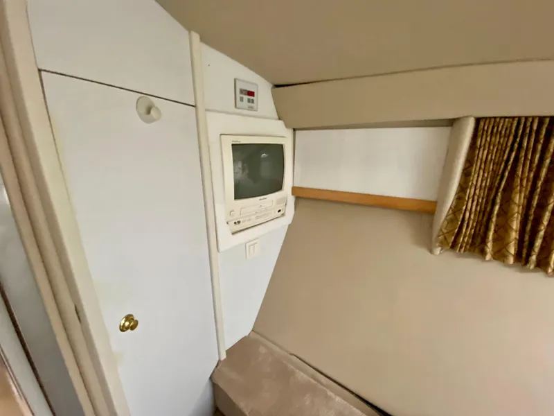 Slide: The Image of 1998 Formula 41 PC cabin interior with vintage TV and storage. - 26