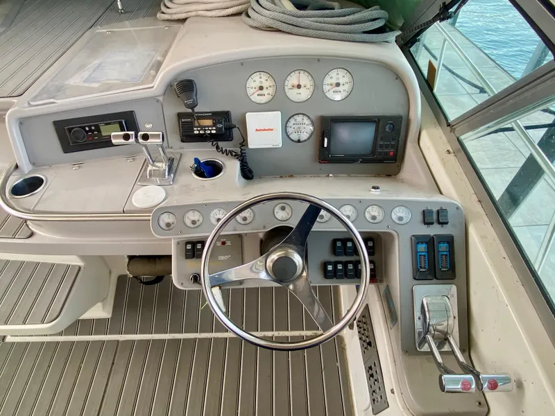 Slide: The Image of 1998 Formula 41 PC boat helm with steering wheel, gauges, and navigation equipment. - 7