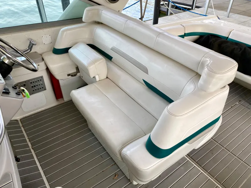 Slide: The Image of 1998 Formula 41 PC boat interior with white leather seating and green accents. - 9