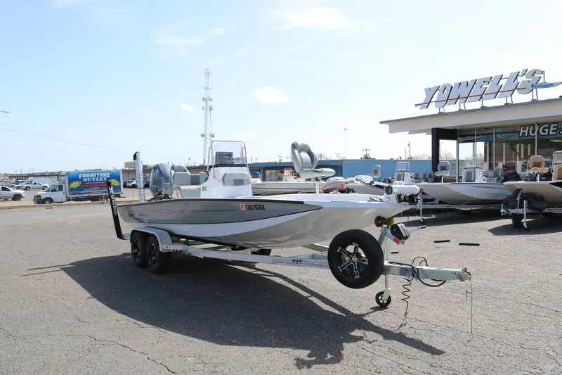 Slide: The Image of 2022 Xpress H22B boat on trailer in dealership parking lot. - 1