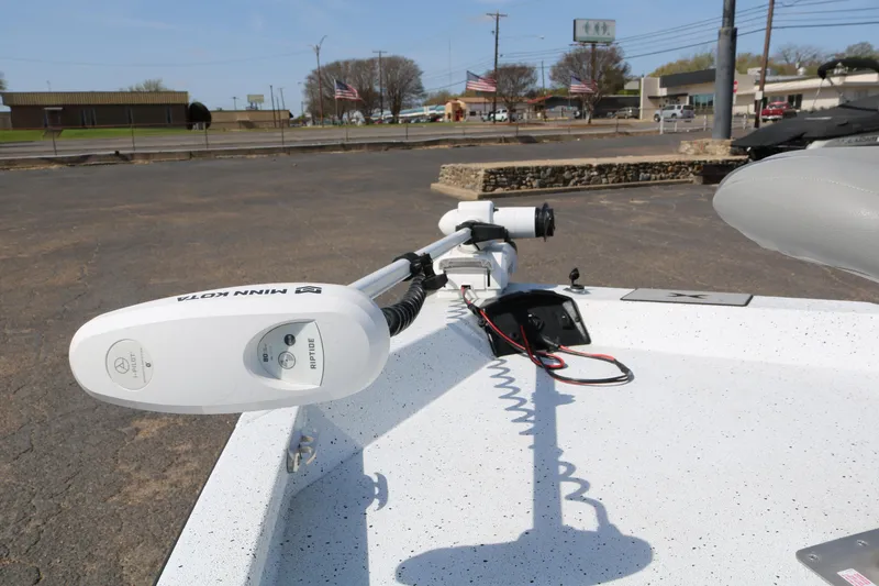 Slide: The Image of 2022 Xpress H22B boat with Minn Kota trolling motor in a parking lot. - 10