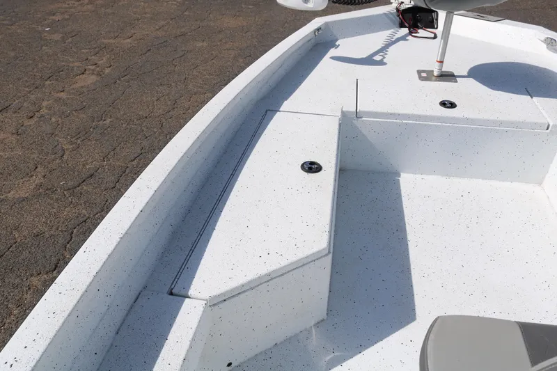 Slide: The Image of 2022 Xpress H22B boat interior with white speckled deck and seating area. - 13