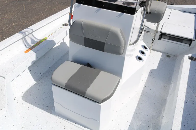 Slide: The Image of 2022 Xpress H22B boat interior with gray seating and console. - 19