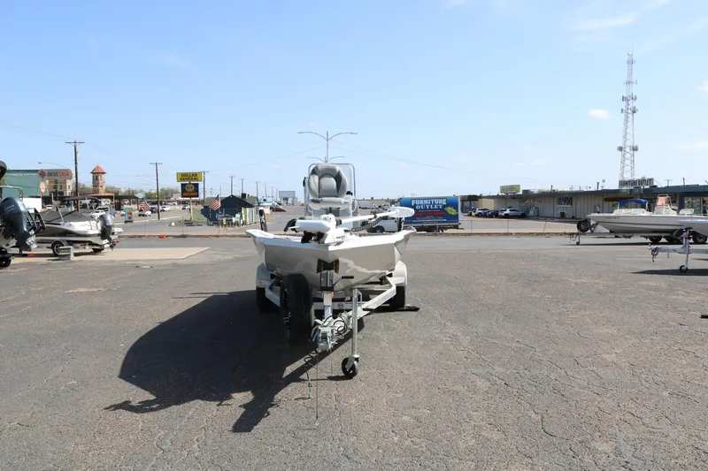 Slide: The Image of 2022 Xpress H22B boat on trailer in parking lot, clear sky background. - 2