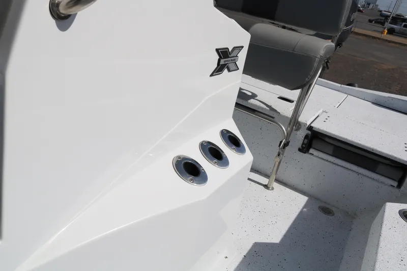 Slide: The Image of 2022 Xpress H22B boat interior with seating and cup holders. - 21