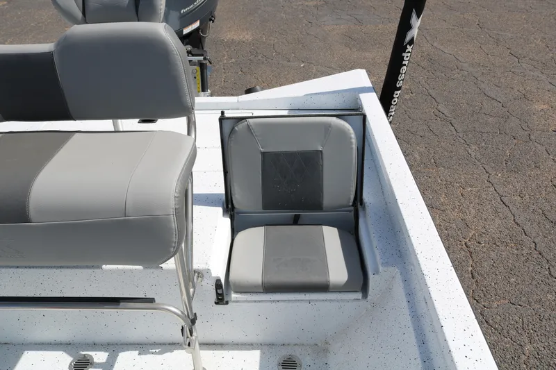 Slide: The Image of 2022 Xpress H22B boat interior with gray seating and white speckled flooring. - 26