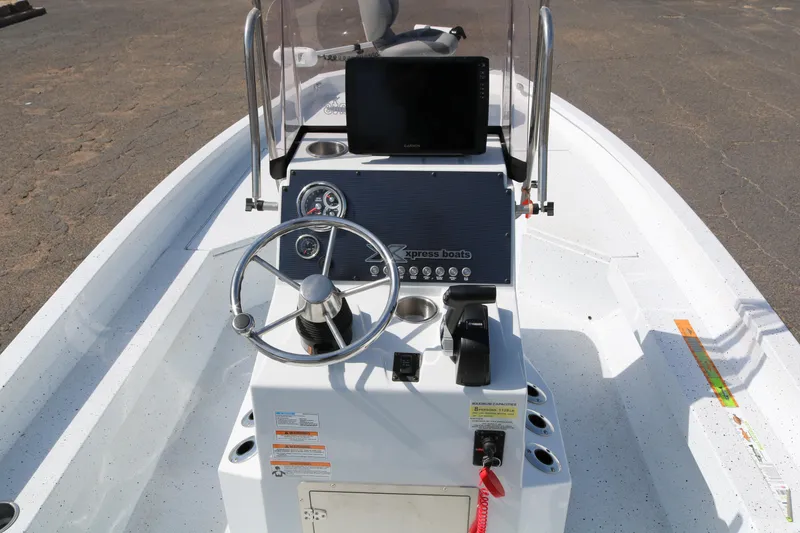 Slide: The Image of 2022 Xpress H22B boat console with steering wheel and navigation display. - 33