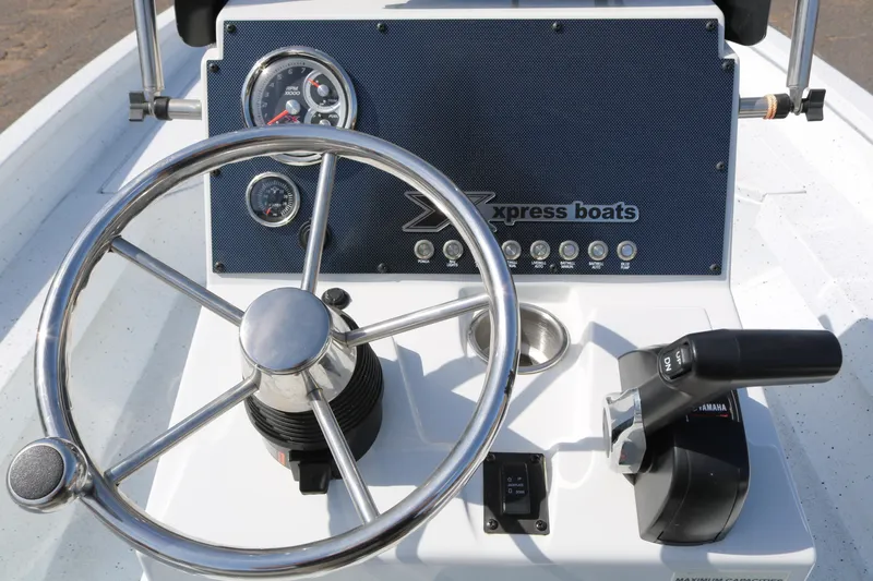 Slide: The Image of 2022 Xpress H22B boat dashboard with steering wheel and controls. - 34