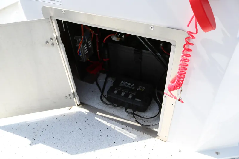 Slide: The Image of Open compartment of 2022 Xpress H22B boat showing electrical components and wiring. - 36