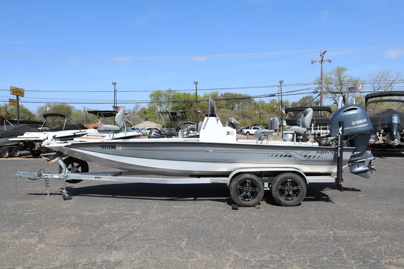 Slide: The Image of 2022 Xpress H22B boat on trailer, parked outdoors, side view. - 4