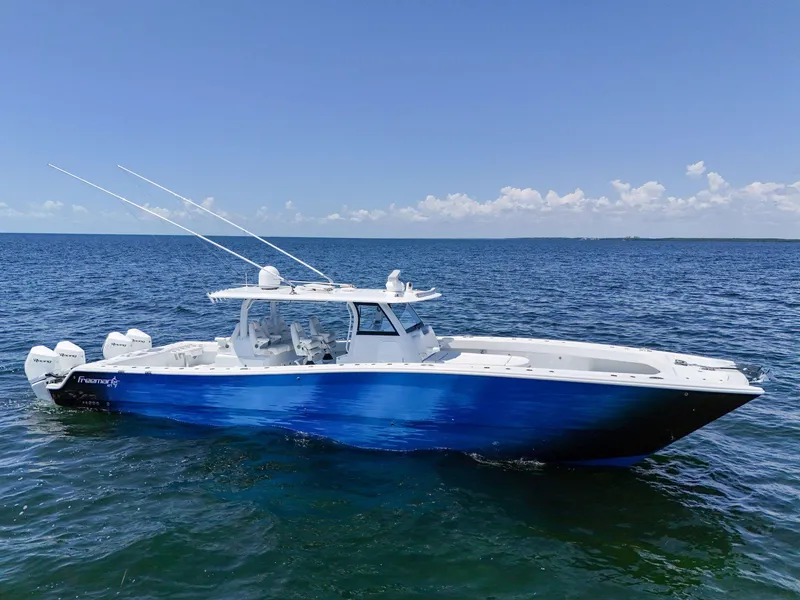 Slide: The Image of 2023 Freeman 47 boat on open sea under clear blue sky. - 10