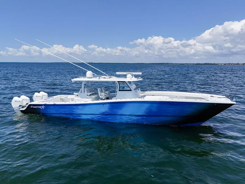 Slide: The Image of 2023 Freeman 47 boat on open water under clear blue sky. - 11