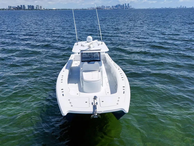 Slide: The Image of Freeman 47 boat, 2023 model, cruising on open water with city skyline in background. - 14