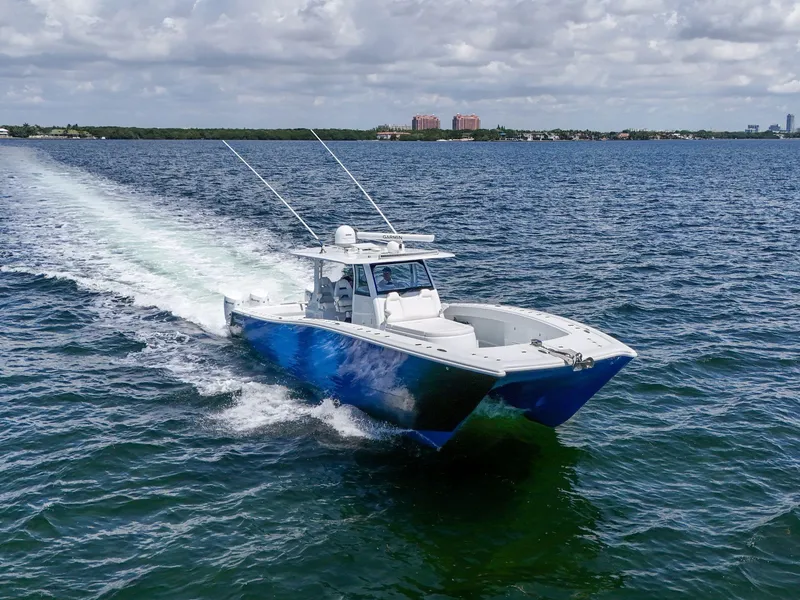 Slide: The Image of 2023 Freeman 47 boat cruising on open water under cloudy skies. - 20