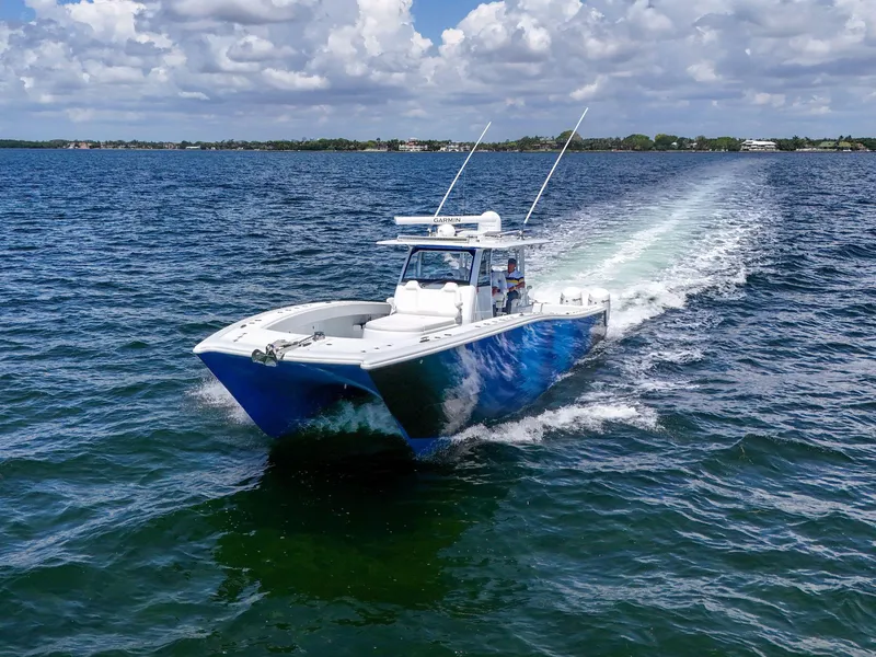 Slide: The Image of 2023 Freeman 47 boat cruising on open water under a partly cloudy sky. - 21