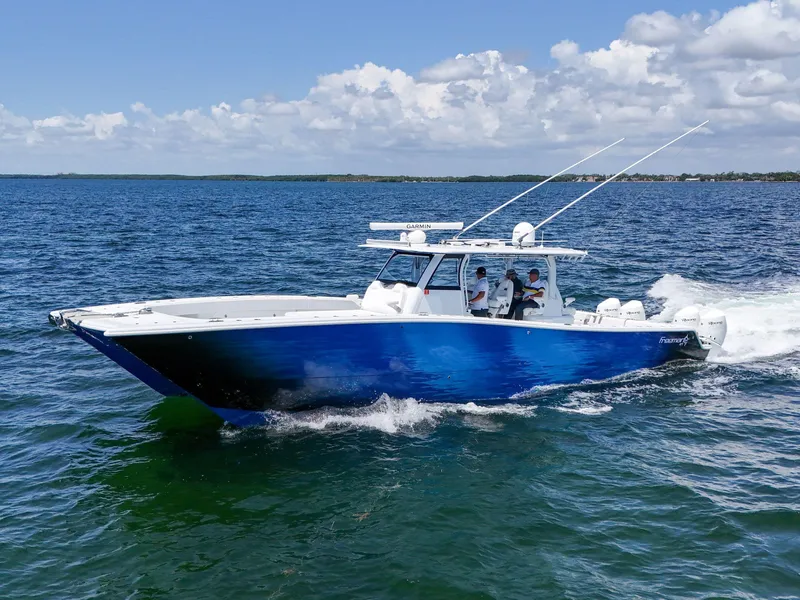 Slide: The Image of 2023 Freeman 47 boat cruising on open water under a partly cloudy sky. - 22