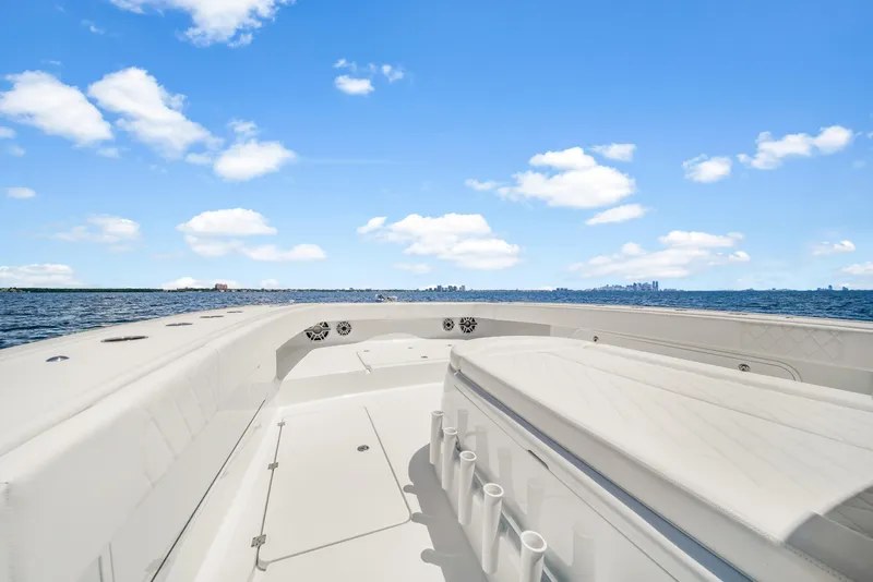 Slide: The Image of 2023 Freeman 47 boat on open water under a clear blue sky. - 28