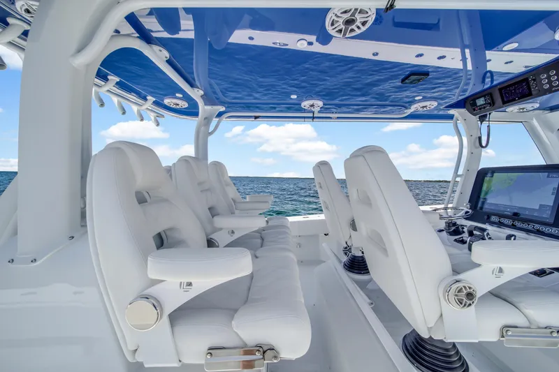 Slide: The Image of Freeman 47 boat interior, 2023 model, featuring luxurious white seating and advanced navigation systems. - 38
