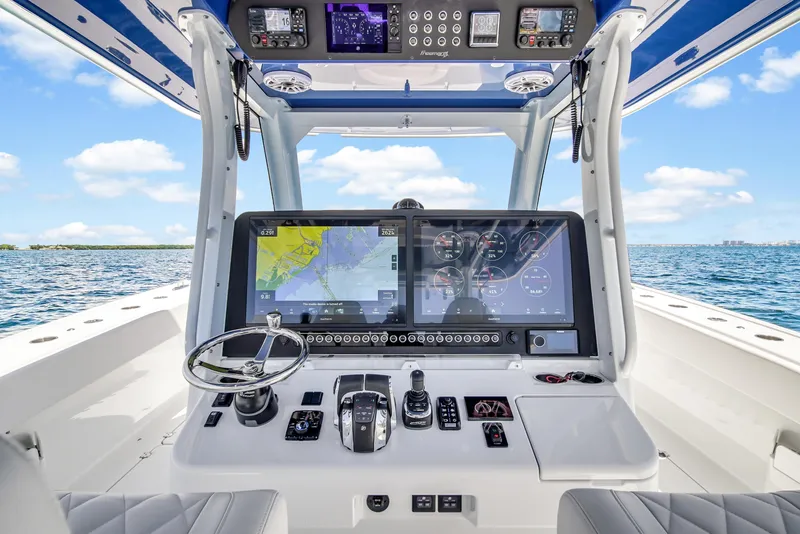 Slide: The Image of Freeman 47 boat cockpit with advanced navigation system, 2023 model, on open water. - 42