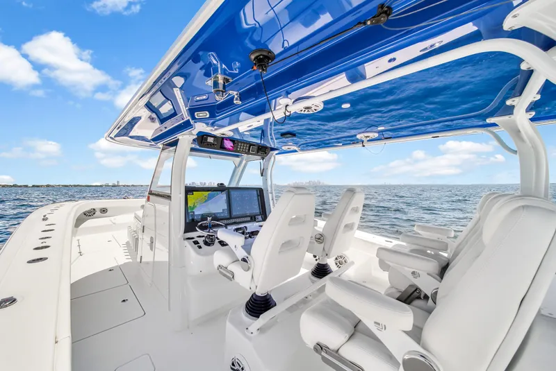 Slide: The Image of 2023 Freeman 47 boat interior with advanced navigation system and luxurious seating on open water. - 44