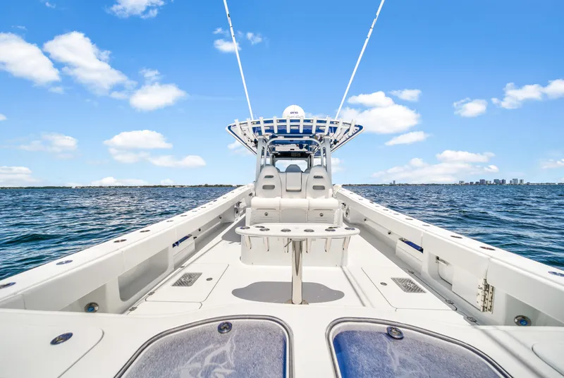 Slide: The Image of 2023 Freeman 47 boat on open water under clear blue sky. - 48