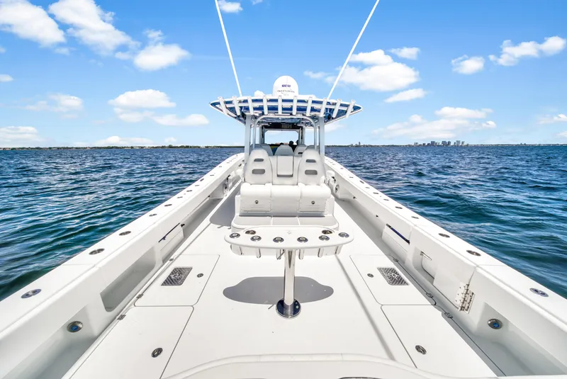 Slide: The Image of 2023 Freeman 47 boat on open water under clear blue sky. - 49