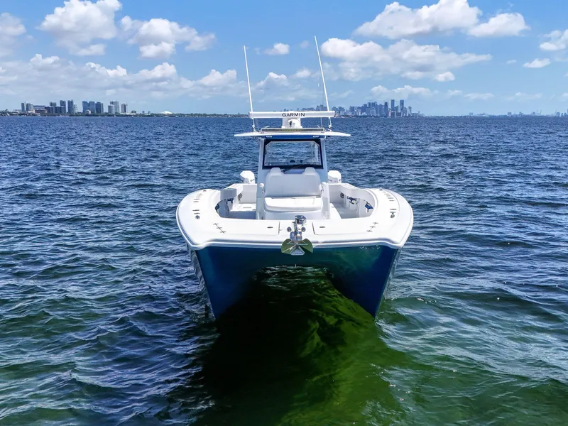 Slide: The Image of 2023 Freeman 47 boat on open water with city skyline in background. - 5
