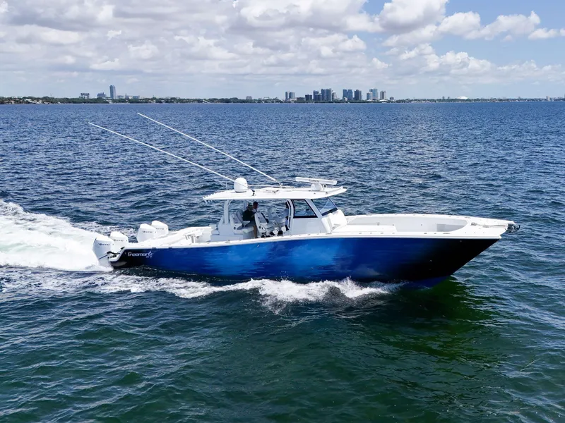 Slide: The Image of 2023 Freeman 47 boat cruising on open water under a partly cloudy sky. - 6
