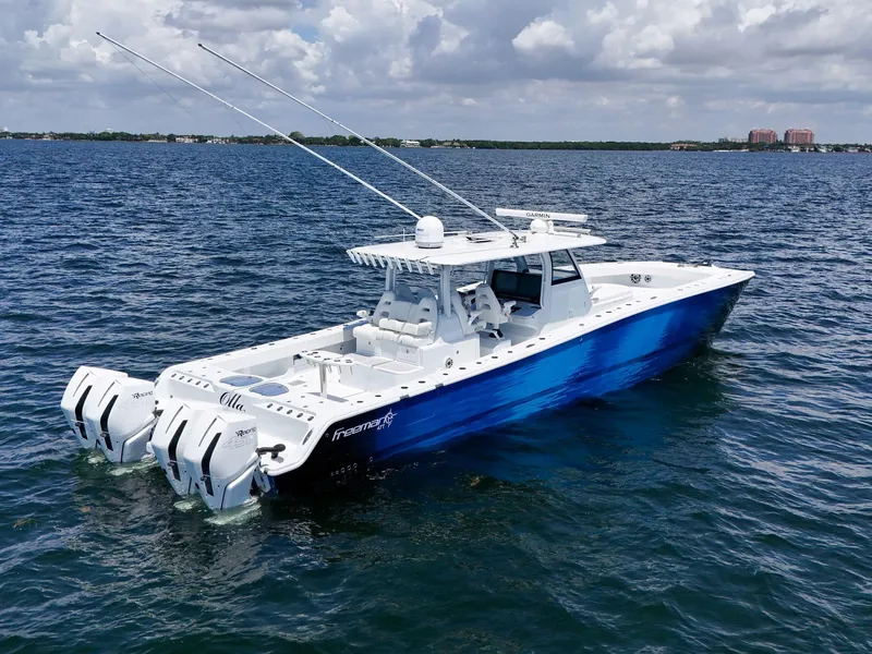 Slide: The Image of 2023 Freeman 47 boat on open water with dual outboard motors. - 8