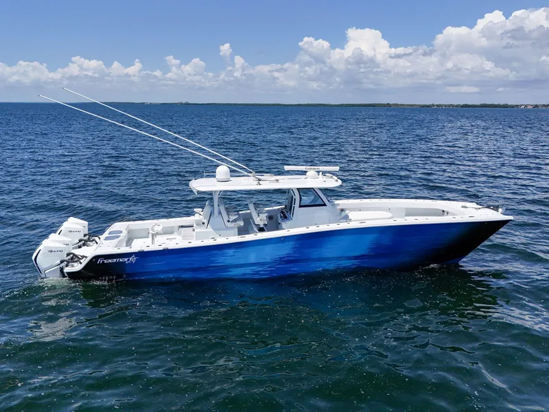 Slide: The Image of 2023 Freeman 47 boat on open water under a clear blue sky. - 9