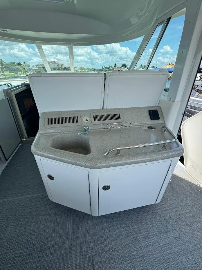 Slide: The Image of 2006 Sea Ray 40 Motor Yacht kitchenette with sink and storage, featuring modern design. - 12