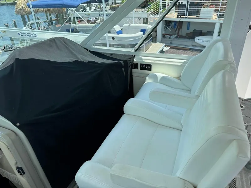 Slide: The Image of White seating area on 2006 Sea Ray 40 Motor Yacht, docked with covered equipment. - 14